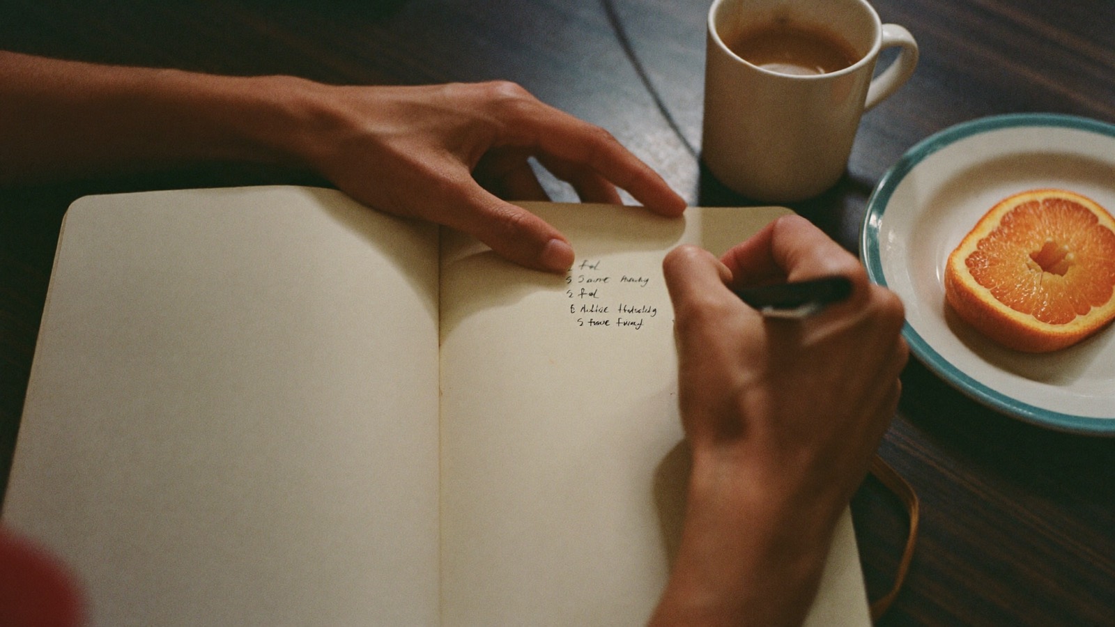Writing a checklist in a notebook