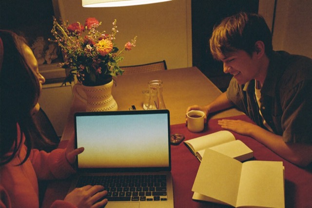 A couple planning at a laptop and notebook