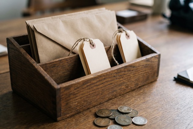Labeled envelopes in a wooden organizer