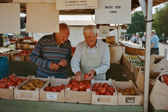 An older couple laughing at a market stall