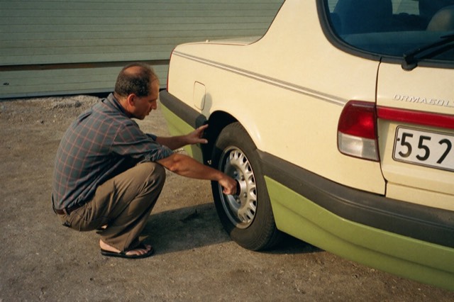 Inspecting a used hatchback in a driveway