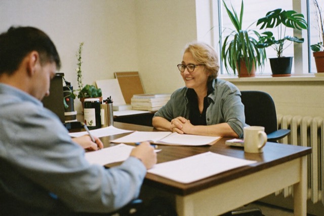 A counselor talking warmly across a desk