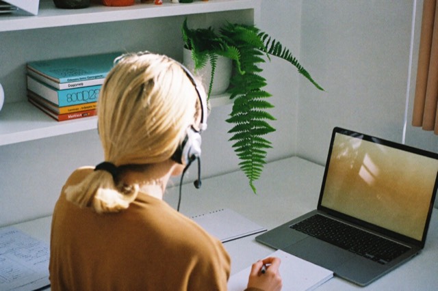 Working with a headset at a tidy bright desk