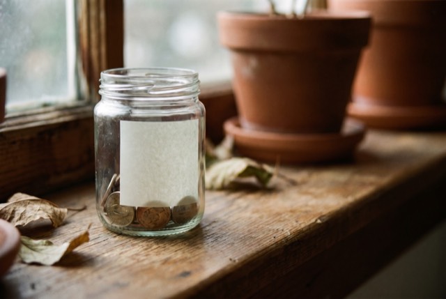 A small jar with a few coins