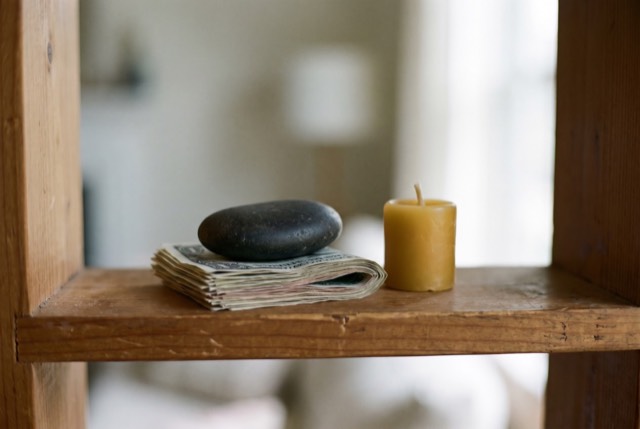 Folded bills under a smooth stone